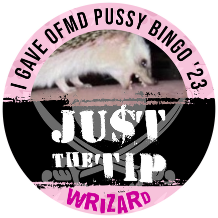 A round badge with text along the top reading "I Gave OFMD Pussy Bingo '23," followed by a large streak across the middle with text reading "JUST THE TIP" with the S of Just written as a $. Along the bottom text reads "Wrizard." The central image is an ang